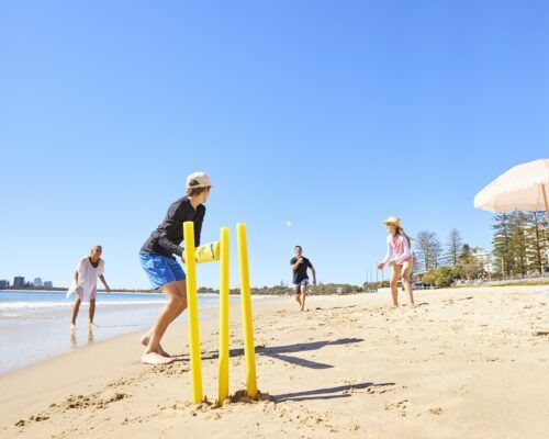 Playing cricket on the beach